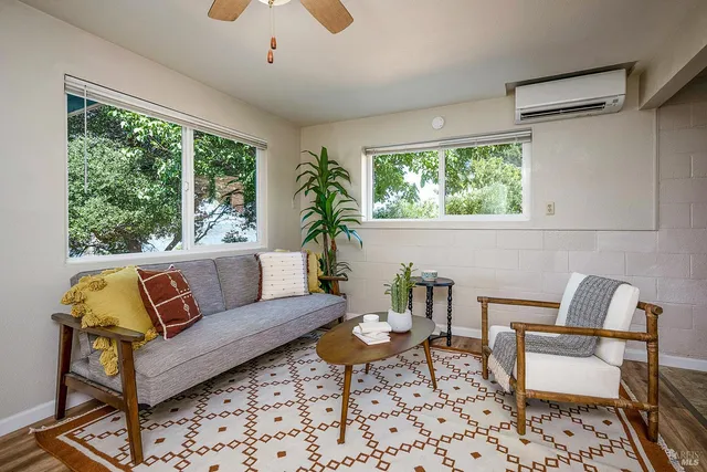 a living room with furniture and a large window