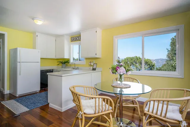a kitchen with a table chairs and refrigerator