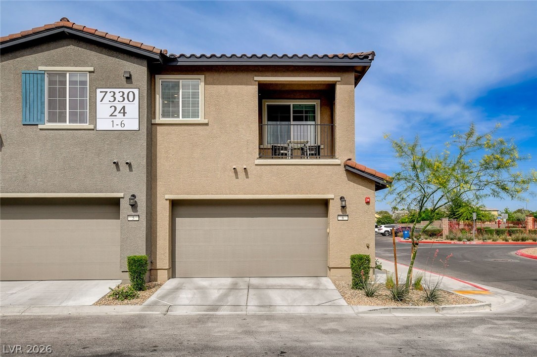 7330 North Decatur Boulevard, Unit 6 North Las Vegas, NV 89084 - Photo 1 of 42 A well-maintained stucco exterior with attached garages and a private upper-level balcony awaits.
