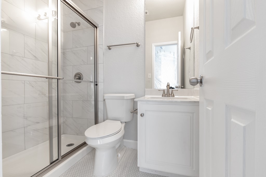 2204 San Gabriel Street, Unit 104 Austin, TX 78705 - Photo 12 of 18 Full bathroom with a stall shower and vanity