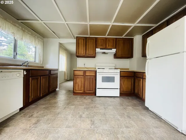 a kitchen with stainless steel appliances granite countertop a stove sink and cabinets