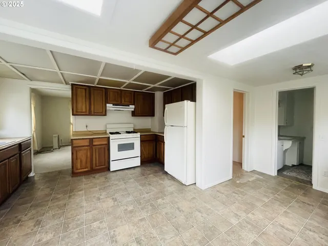 a kitchen with stainless steel appliances a refrigerator and a stove