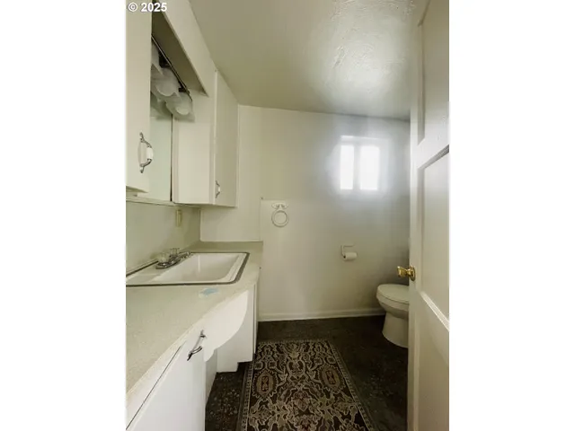 a bathroom with a sink toilet and vanity