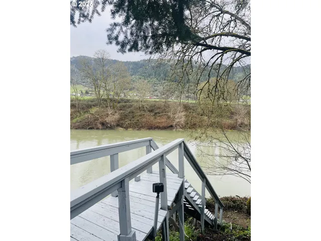 a view of balcony with wooden floor and fence