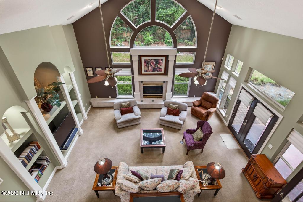 1483 Bridgette Way Fleming Island, FL 32003 - Photo 47 of 63 a living room with furniture a fireplace and a flat screen tv
