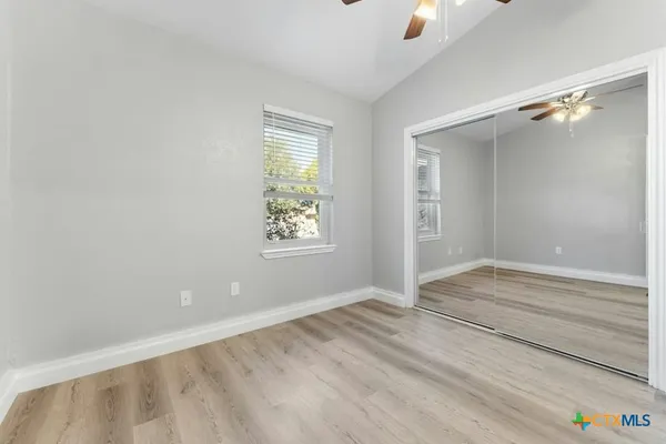 a view of room with window and hardwood floor