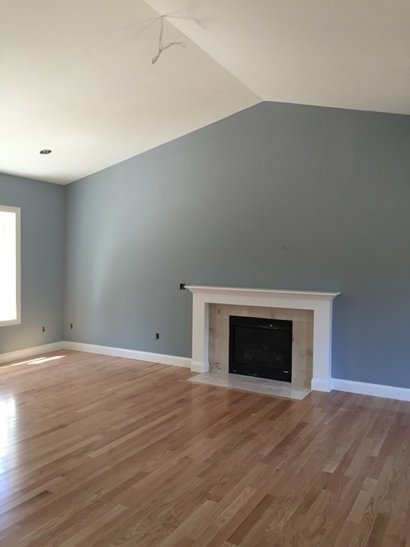 2 Cold Spring Brook Road Hopkinton, MA 01748 - Photo 14 of 20 a view of empty room with wooden floor and fireplace