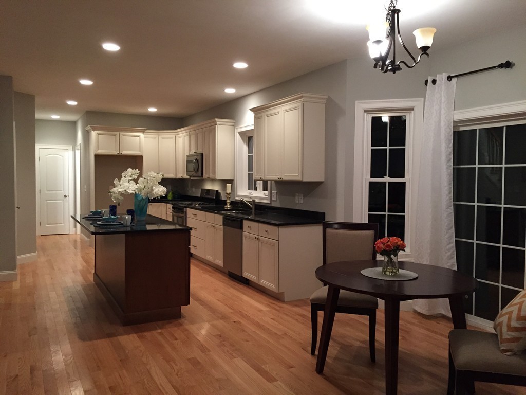 2 Cold Spring Brook Road Hopkinton, MA 01748 - Photo 5 of 20 a kitchen with granite countertop a table chairs stove and cabinets