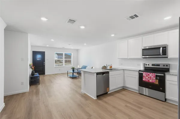 a kitchen with stove and cabinets