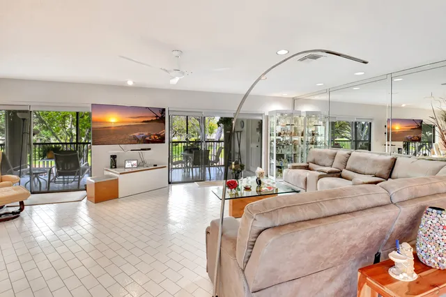 a living room with furniture and kitchen view