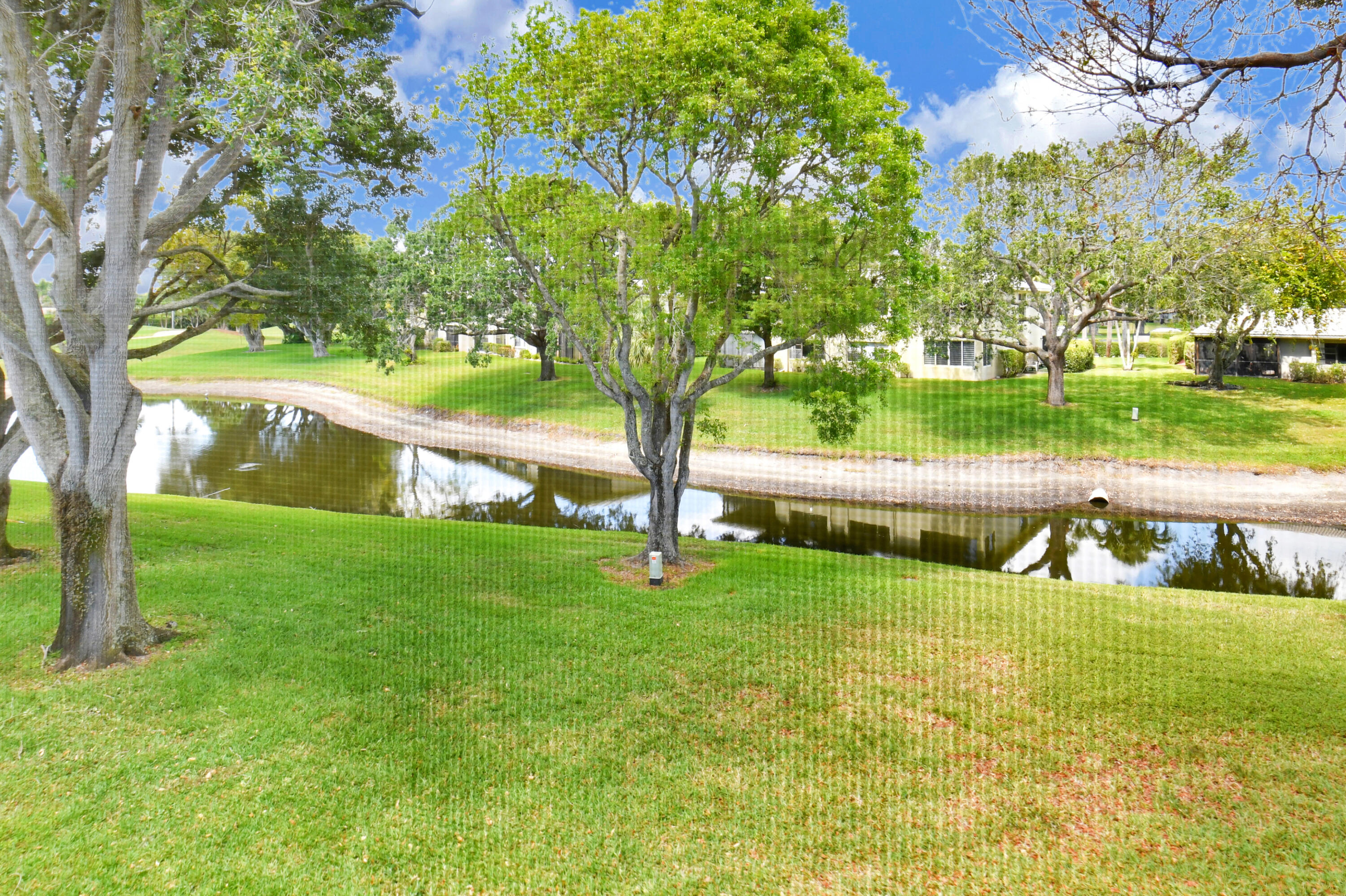 15 Stratford Drive, Unit B Boynton Beach, FL 33436 - Photo 27 of 84 a view of yard with swimming pool and green space