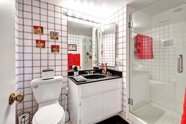 a living room with furniture kitchen view and a chandelier