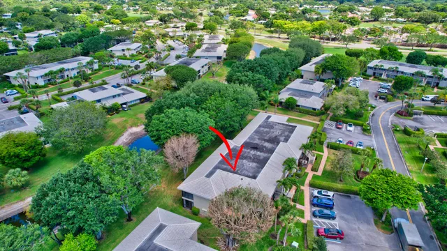 an aerial view of residential houses with outdoor space and trees