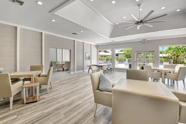a view of a patio with dining table and chairs with plants