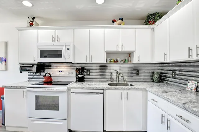 a view of a dining room with furniture a chandelier and wooden floor