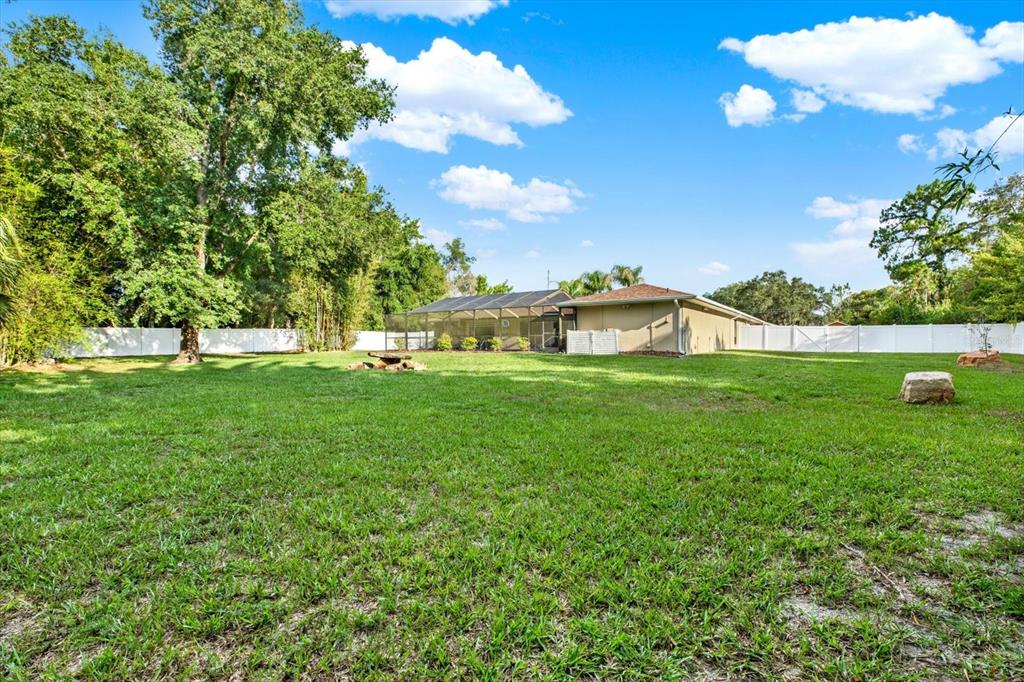 7487 River Country Drive Weeki Wachee, FL 34607 - Photo 47 of 53 a white house with a big yard and large trees