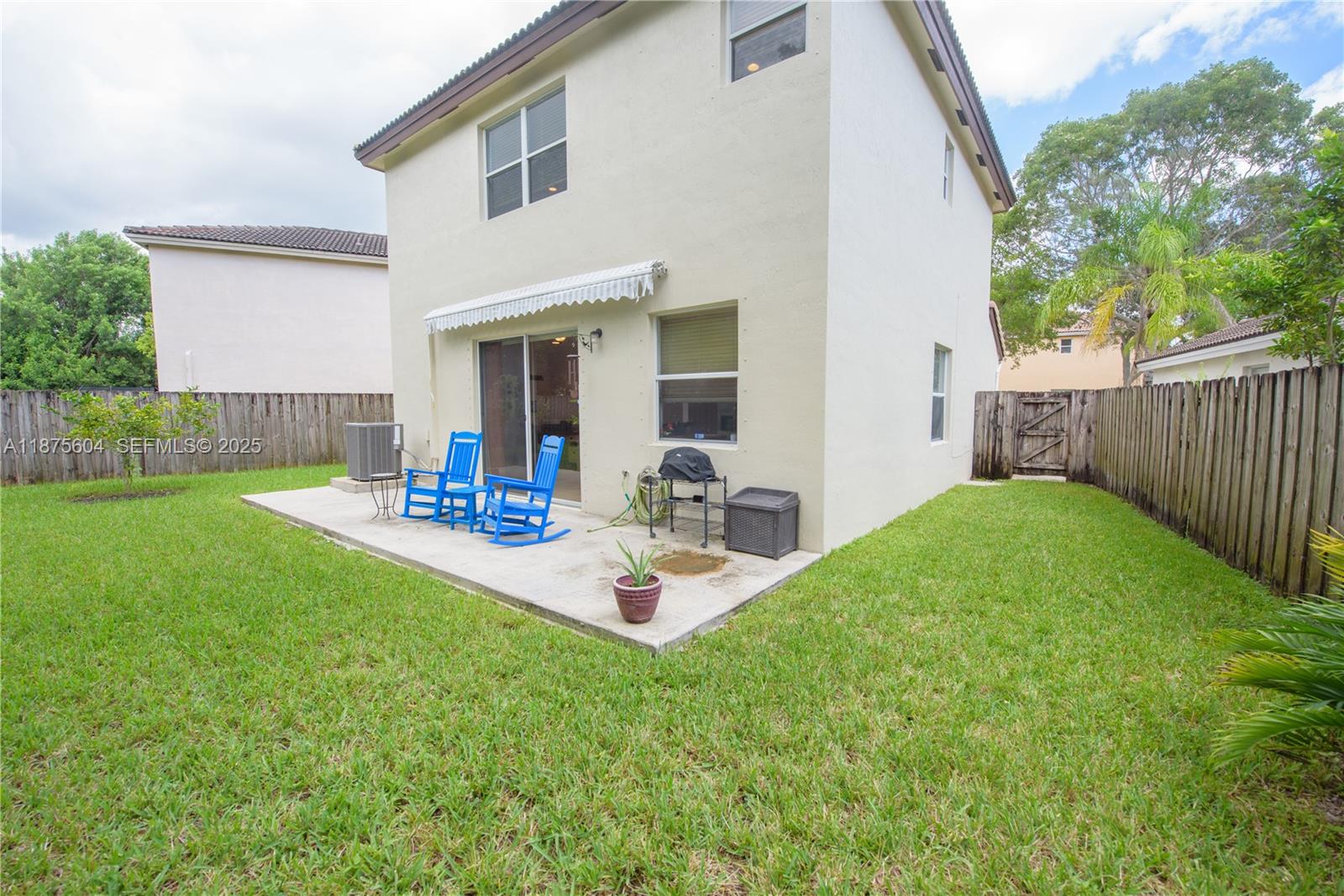1316 Southeast 18th Terrace Homestead, FL 33035 - Photo 22 of 29 a view of backyard of house with wooden deck and outdoor seating