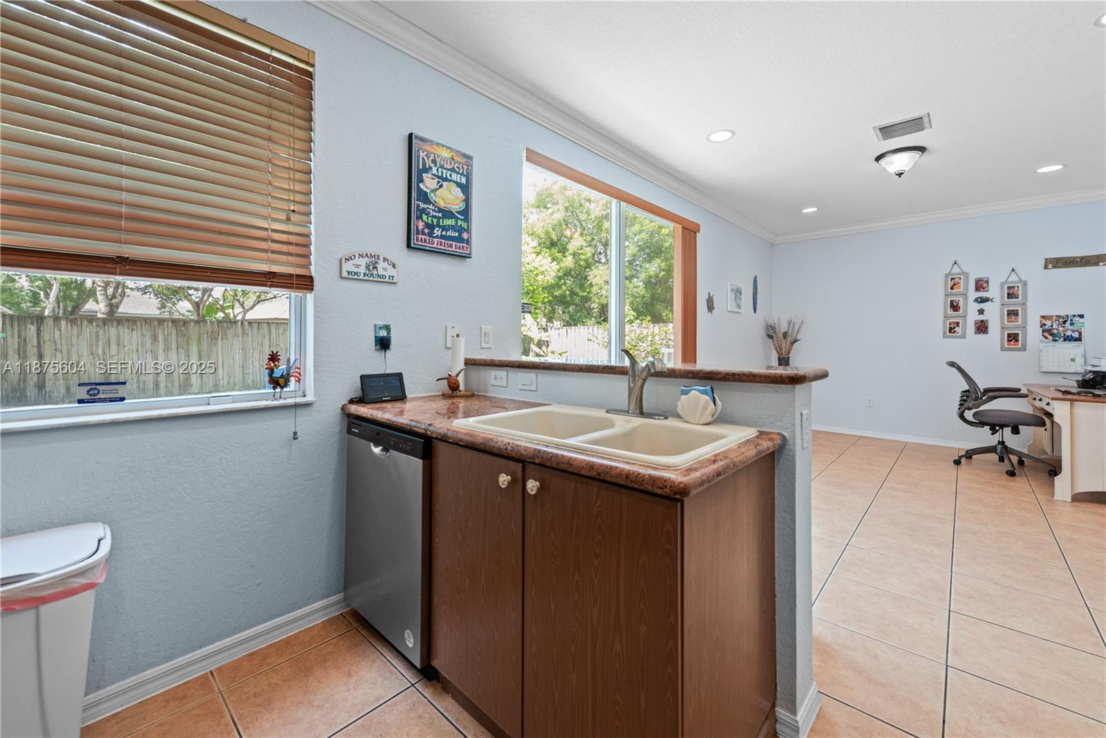 1316 Southeast 18th Terrace Homestead, FL 33035 - Photo 6 of 29 a kitchen that has a sink and a stove in it