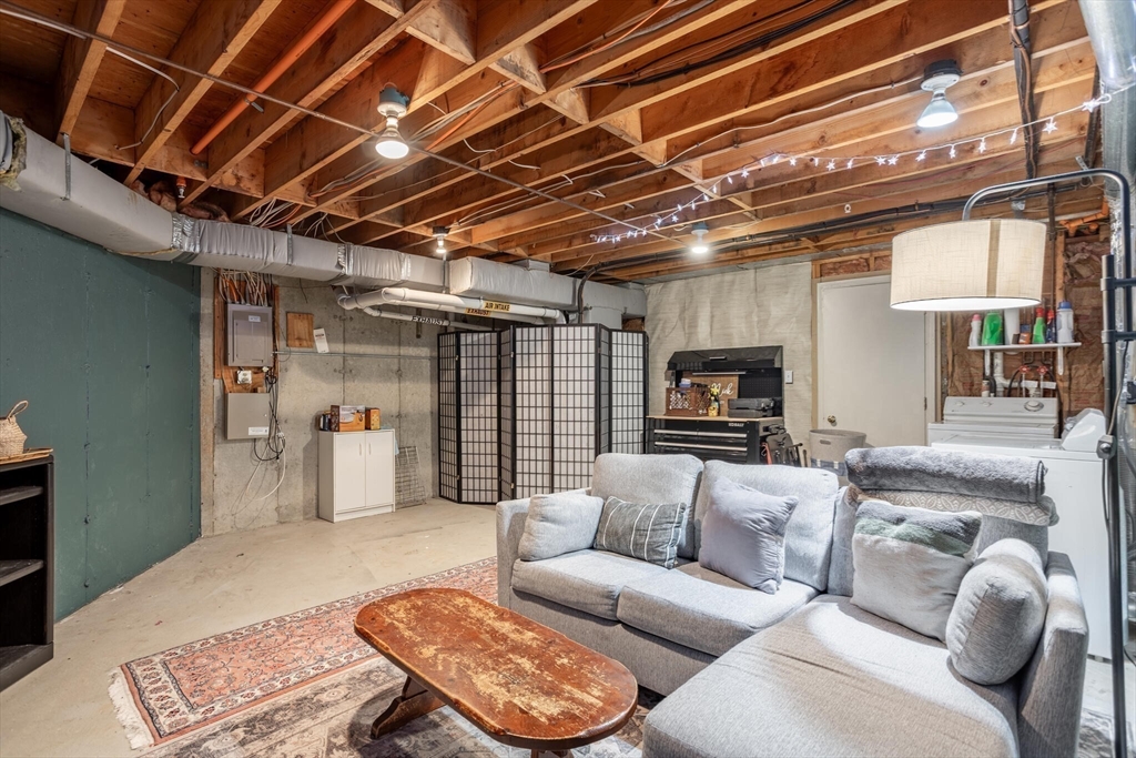 111 Brigham Street, Unit 4D Hudson, MA 01749 - Photo 30 of 39 a living room with furniture and a flat screen tv