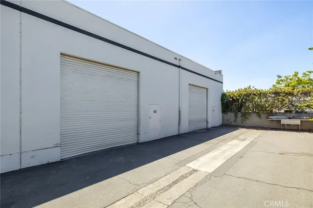 an aerial view of a house with a mountain in the background