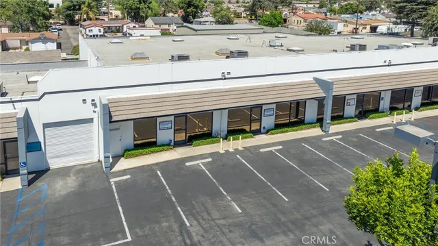 a kitchen with stainless steel appliances kitchen island granite countertop a refrigerator and a sink