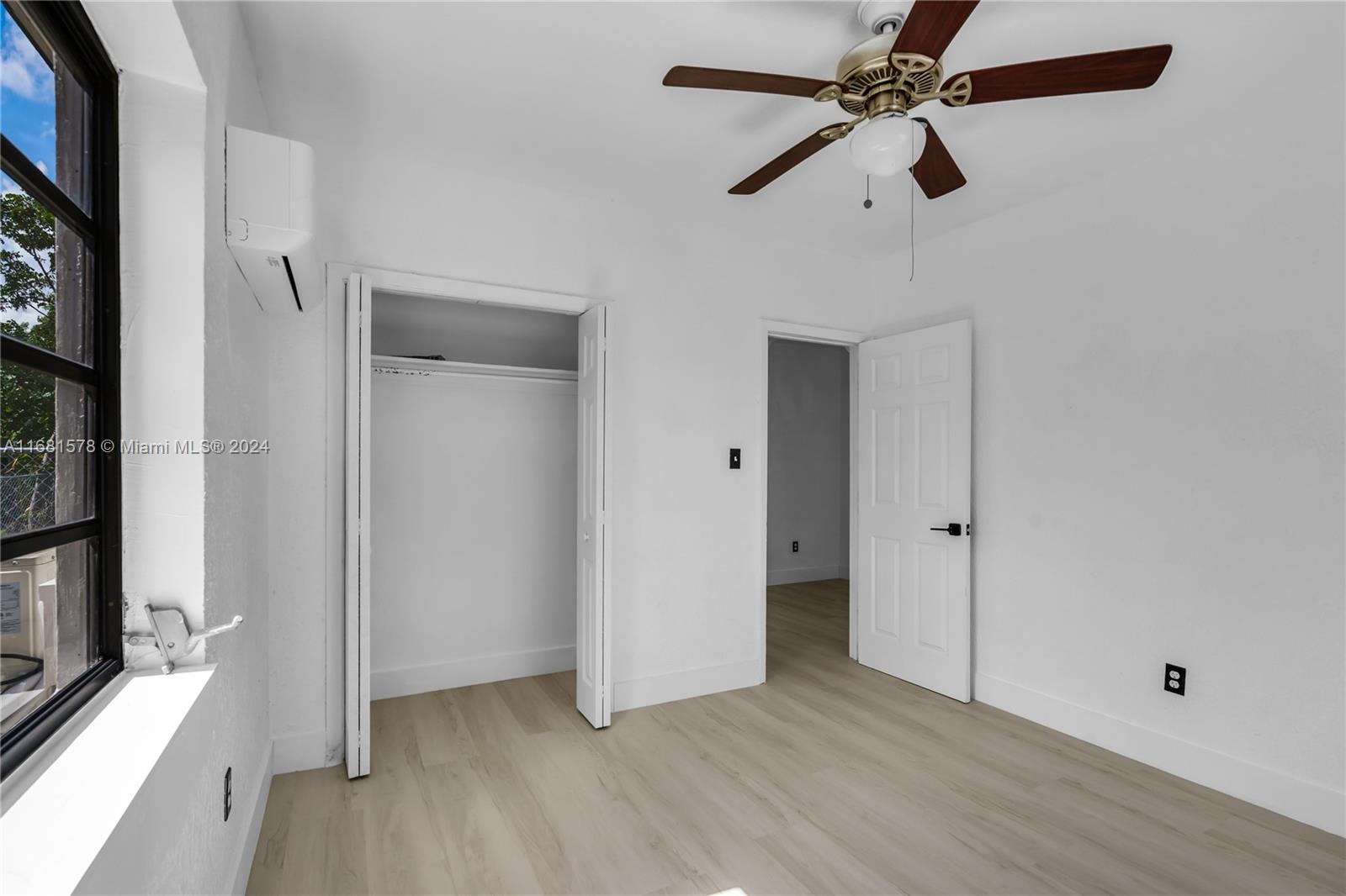 1400 Northwest 55th Street Miami, FL 33142 - Photo 11 of 33 wooden floor in an empty room with a window