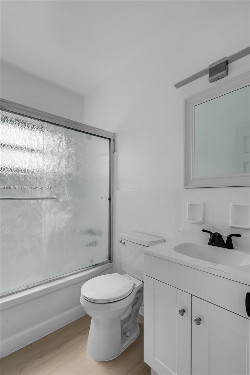 1400 Northwest 55th Street Miami, FL 33142 - Photo 12 of 33 a bathroom with a toilet a sink and a shower