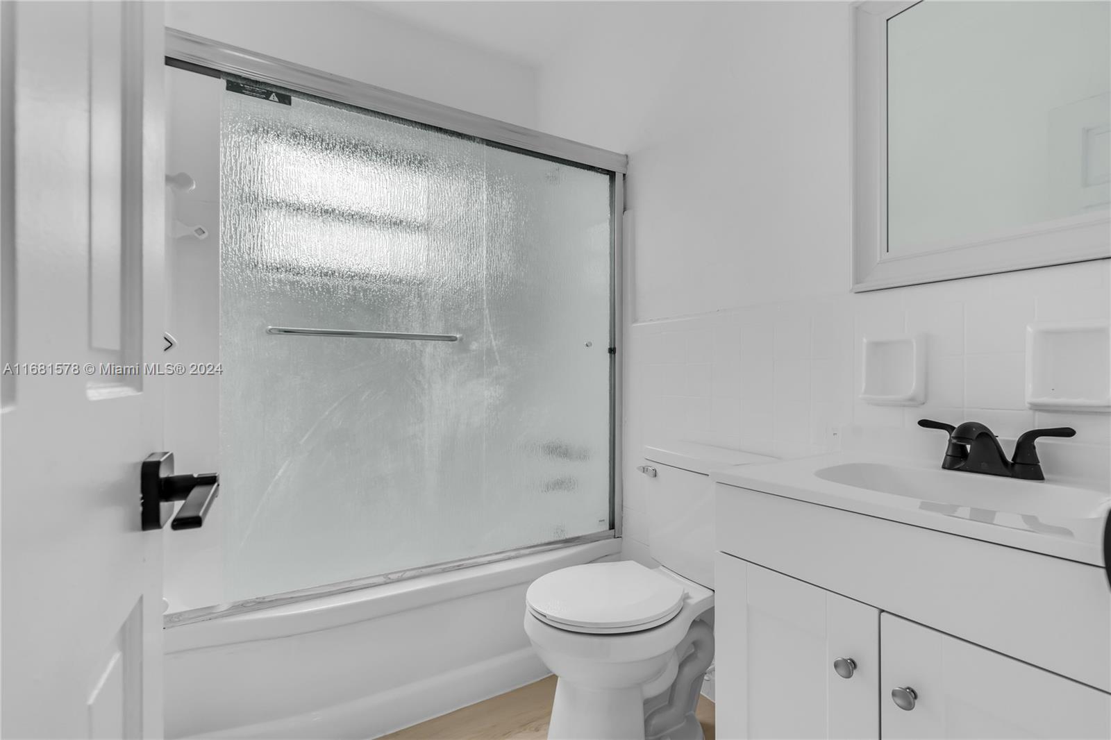 1400 Northwest 55th Street Miami, FL 33142 - Photo 13 of 33 a bathroom with a sink toilet and shower