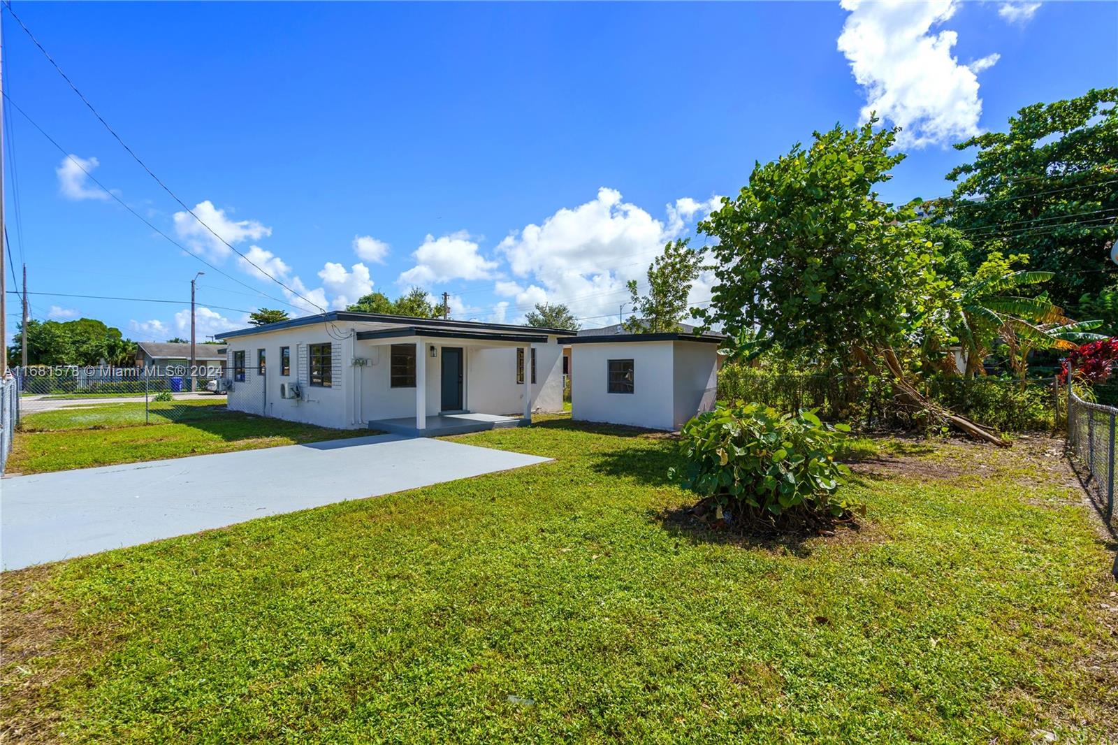 1400 Northwest 55th Street Miami, FL 33142 - Photo 15 of 33 a front view of house with yard and outdoor seating