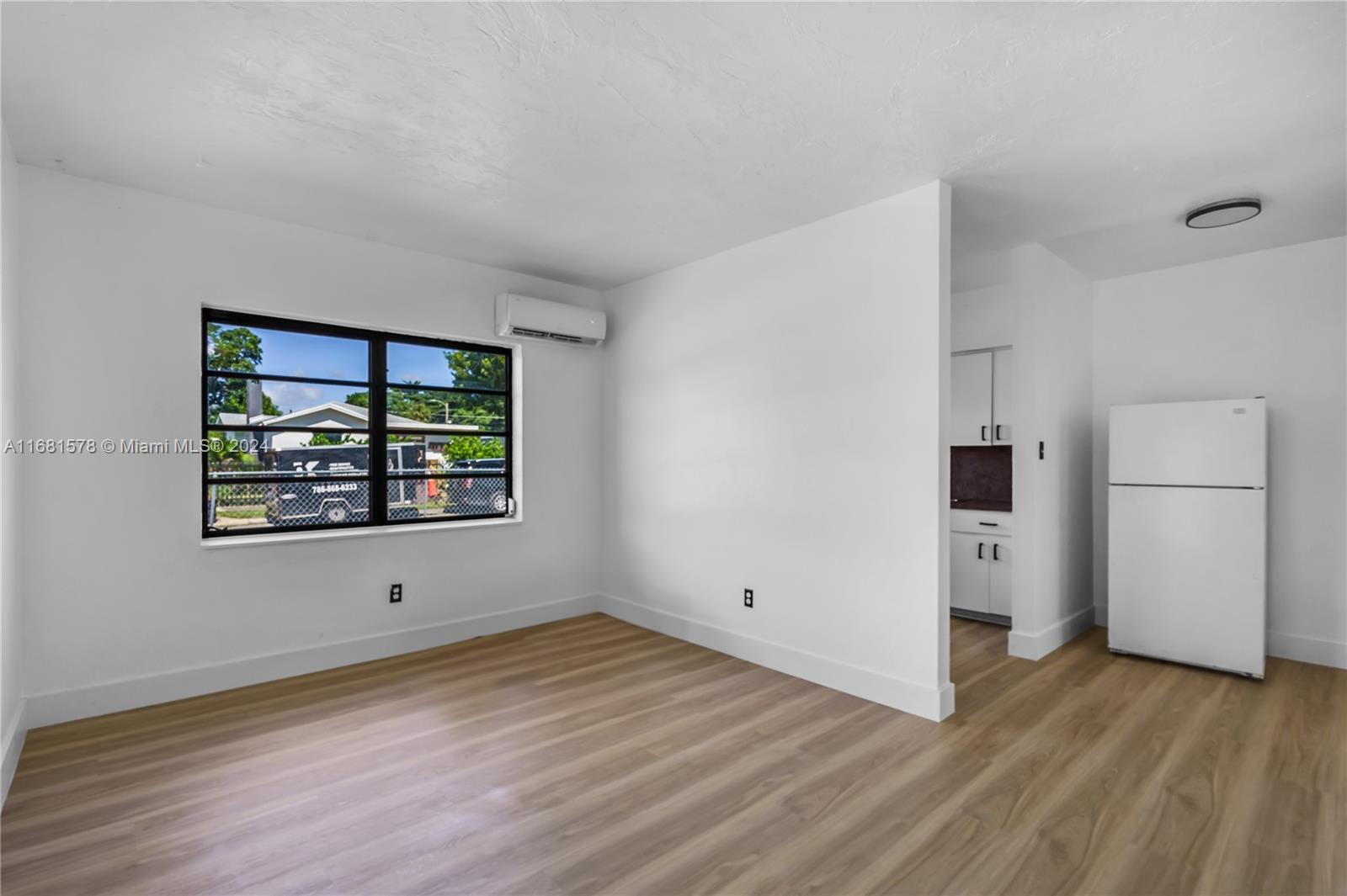 1400 Northwest 55th Street Miami, FL 33142 - Photo 18 of 33 an empty room with wooden floor and a window