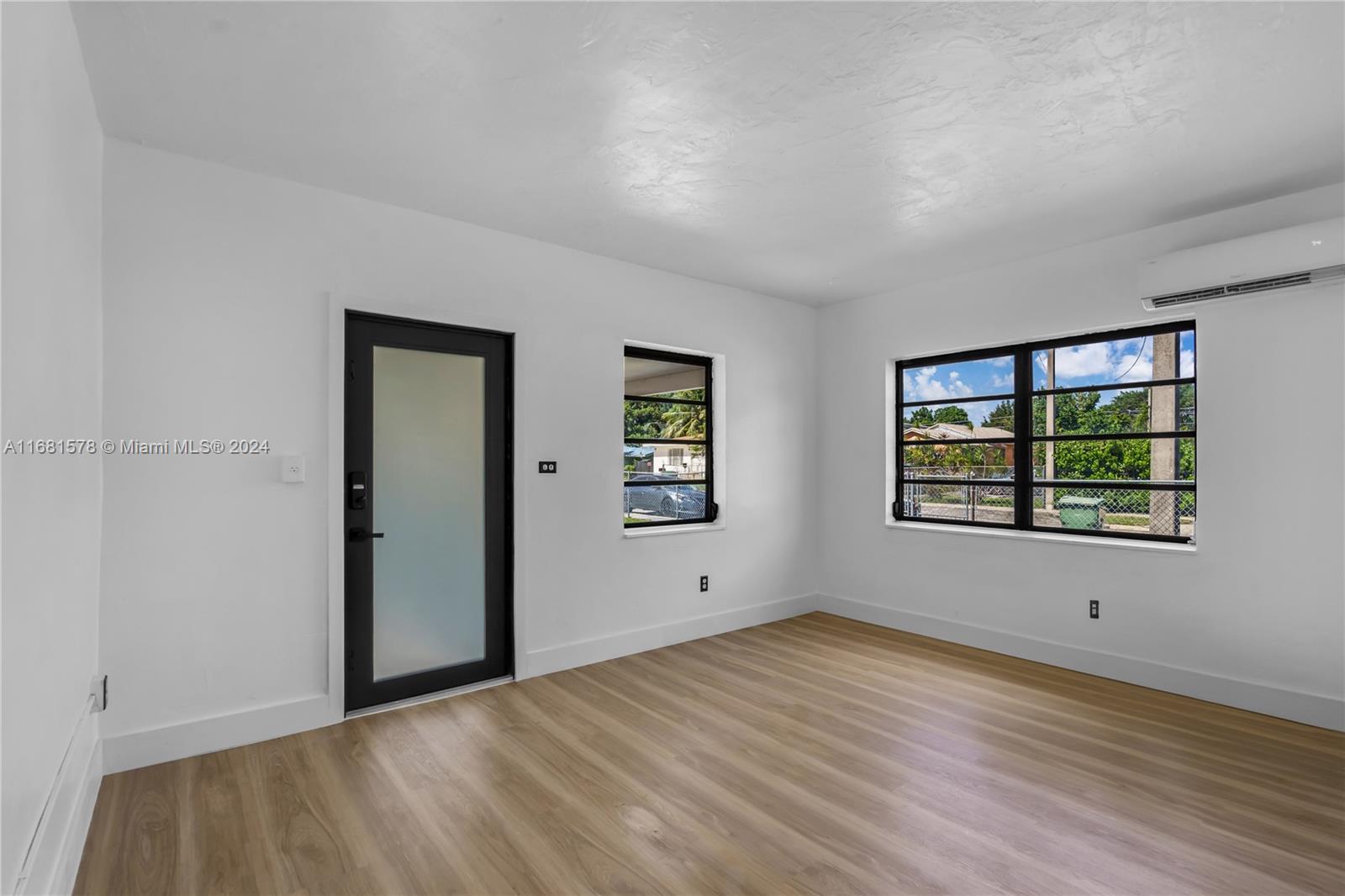 1400 Northwest 55th Street Miami, FL 33142 - Photo 20 of 33 an empty room with wooden floor and windows
