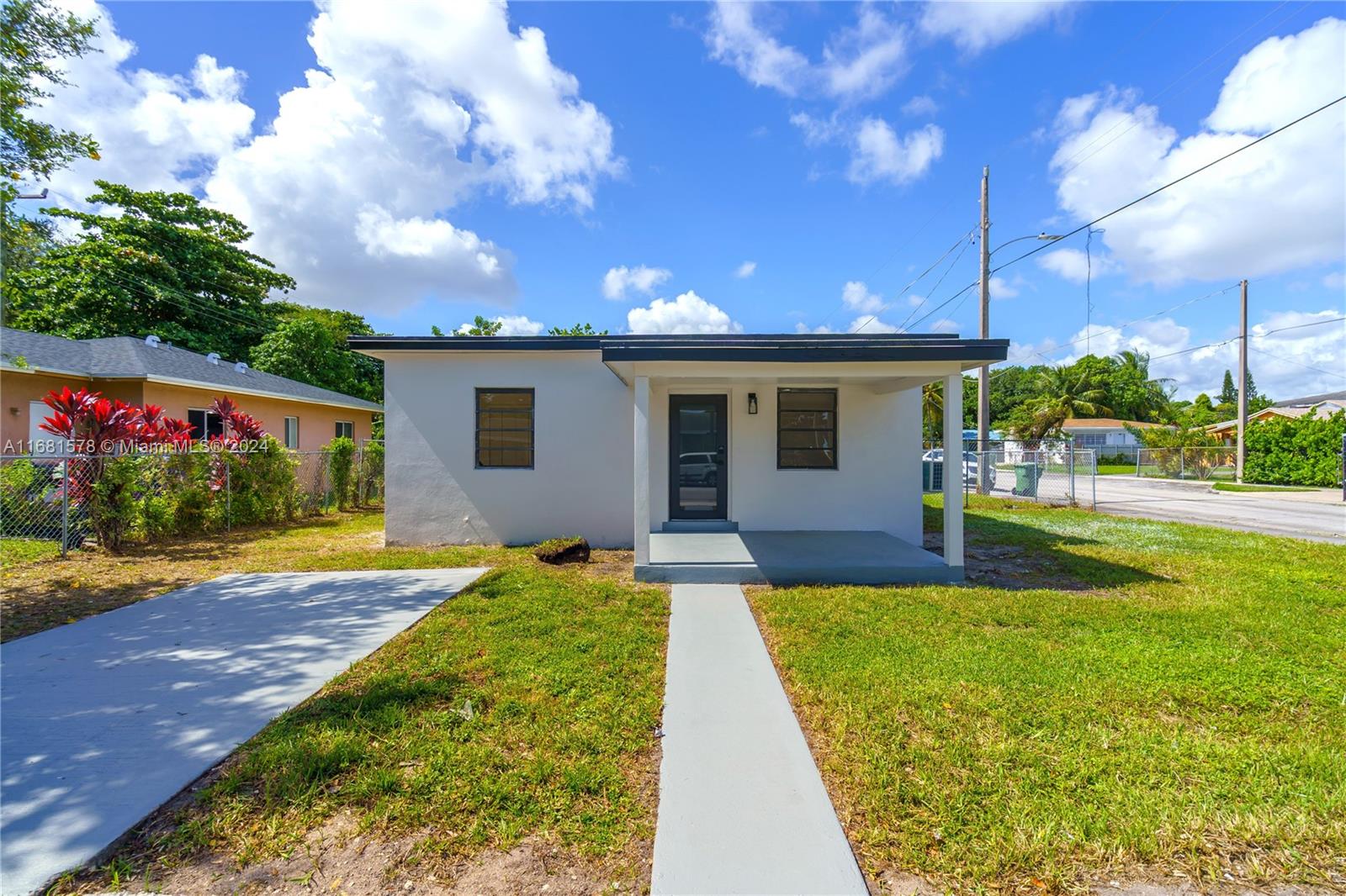 1400 Northwest 55th Street Miami, FL 33142 - Photo 2 of 33 a view of a house with swimming pool and a yard