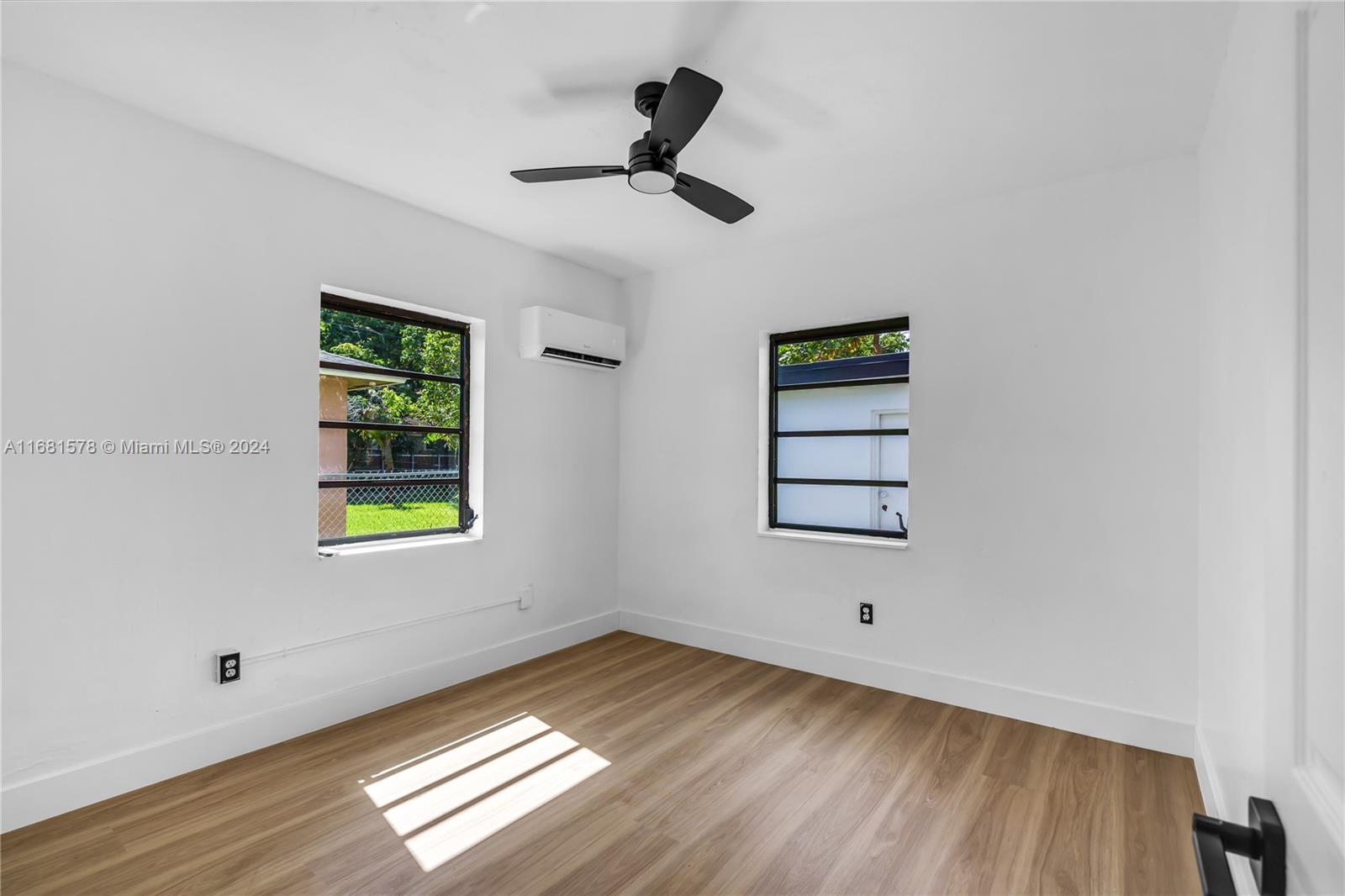 1400 Northwest 55th Street Miami, FL 33142 - Photo 23 of 33 a view of empty room with wooden floor and window