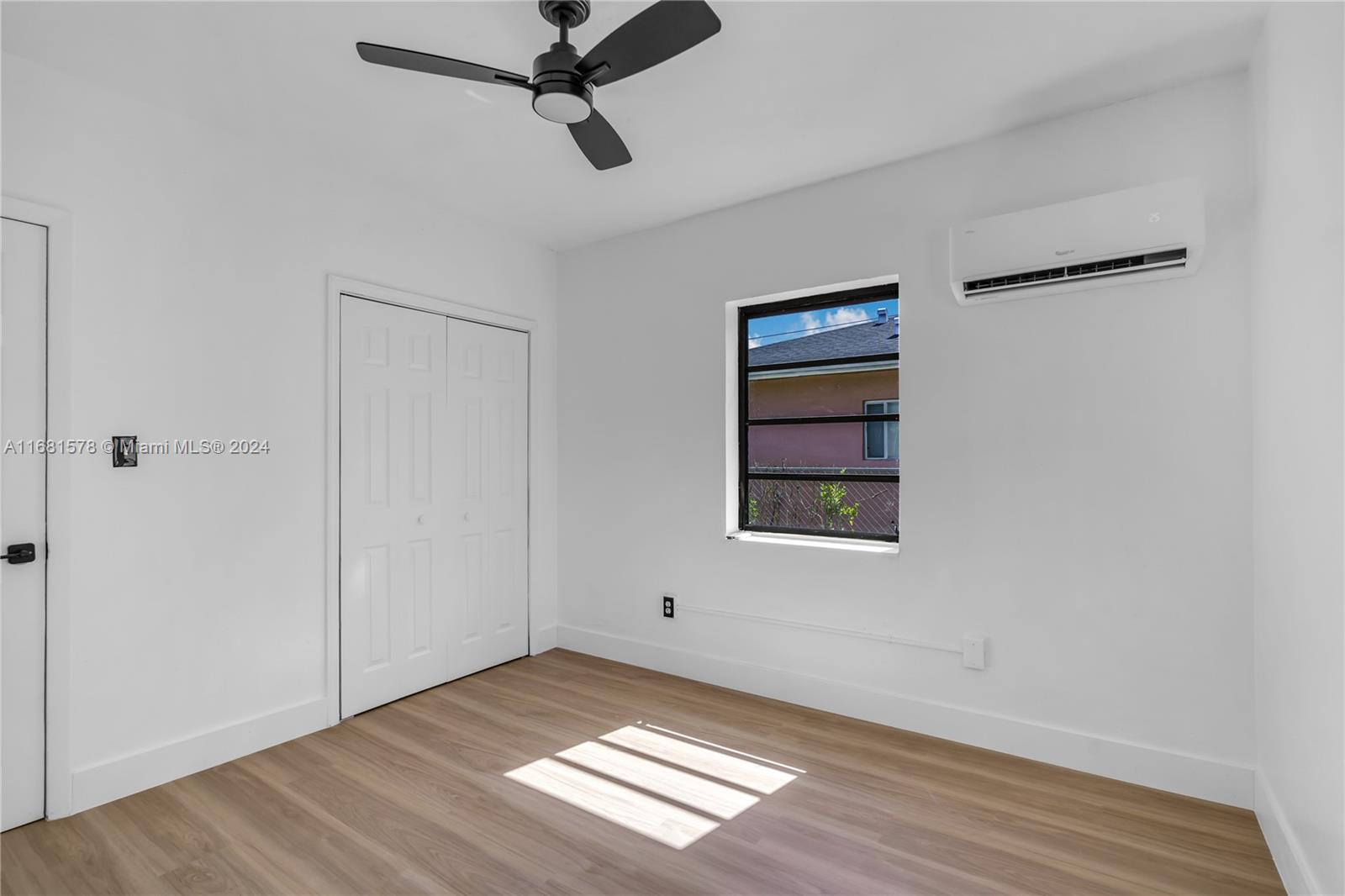 1400 Northwest 55th Street Miami, FL 33142 - Photo 24 of 33 a view of an empty room with wooden floor and a window