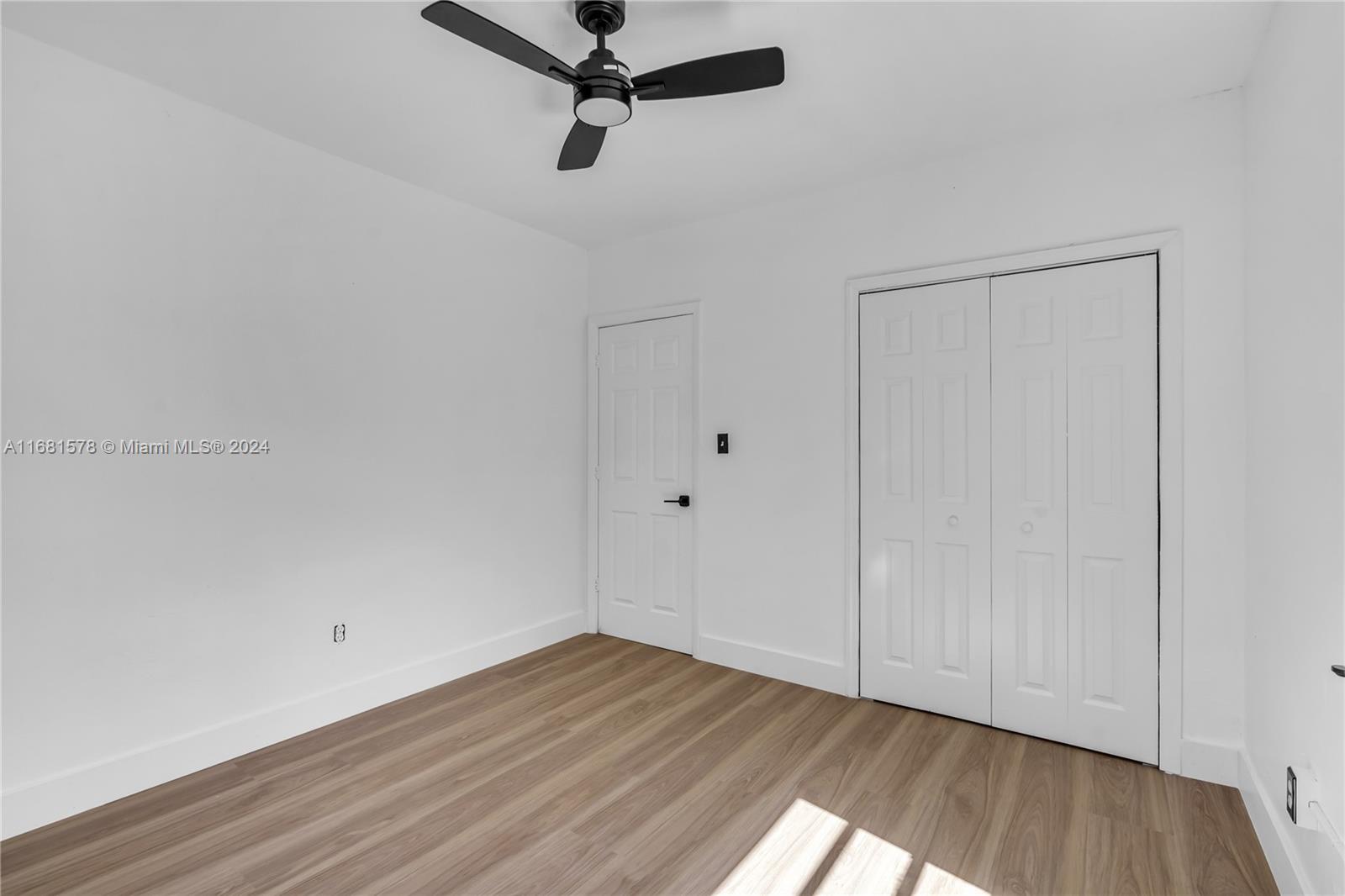 1400 Northwest 55th Street Miami, FL 33142 - Photo 25 of 33 a view of a room with wooden floor closet and windows