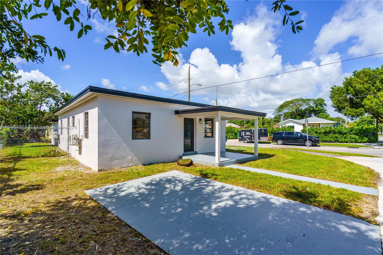 1400 Northwest 55th Street Miami, FL 33142 - Photo 3 of 33 a view of a house with swimming pool and a yard