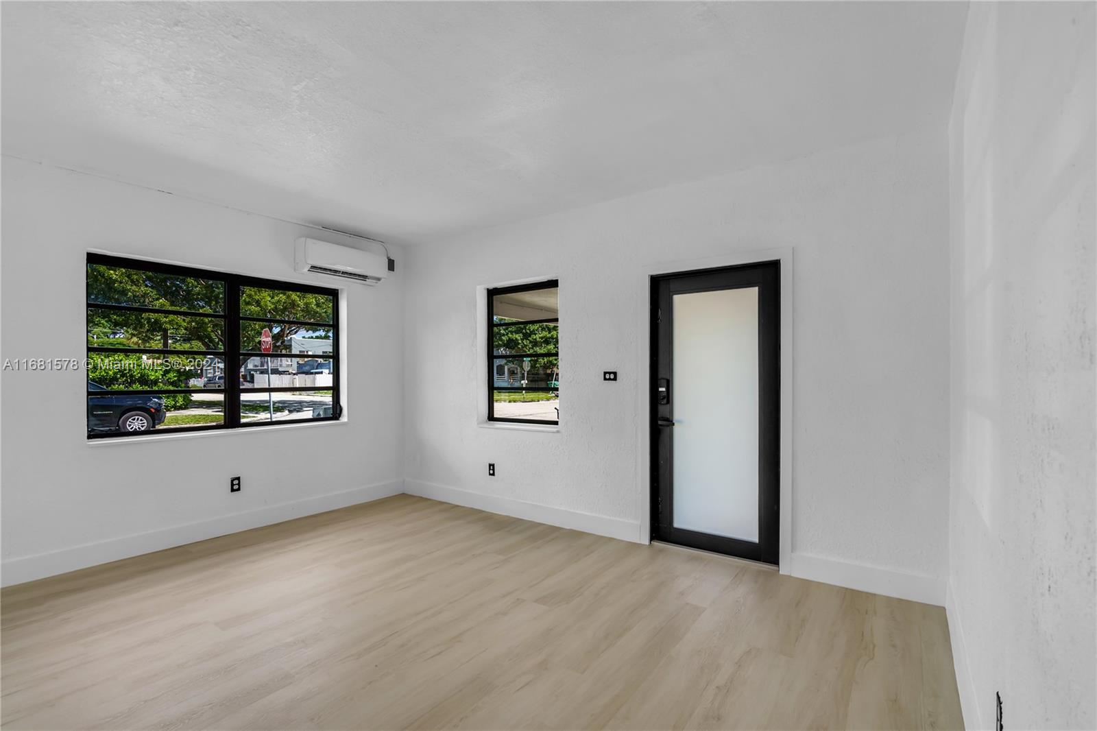 1400 Northwest 55th Street Miami, FL 33142 - Photo 5 of 33 an empty room with windows