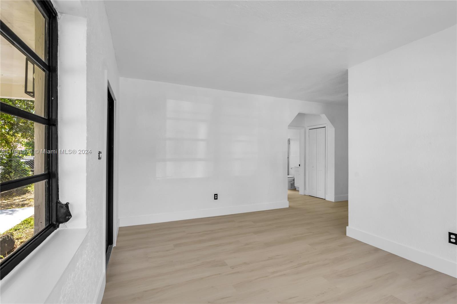 1400 Northwest 55th Street Miami, FL 33142 - Photo 6 of 33 a view of empty room with wooden floor and fan