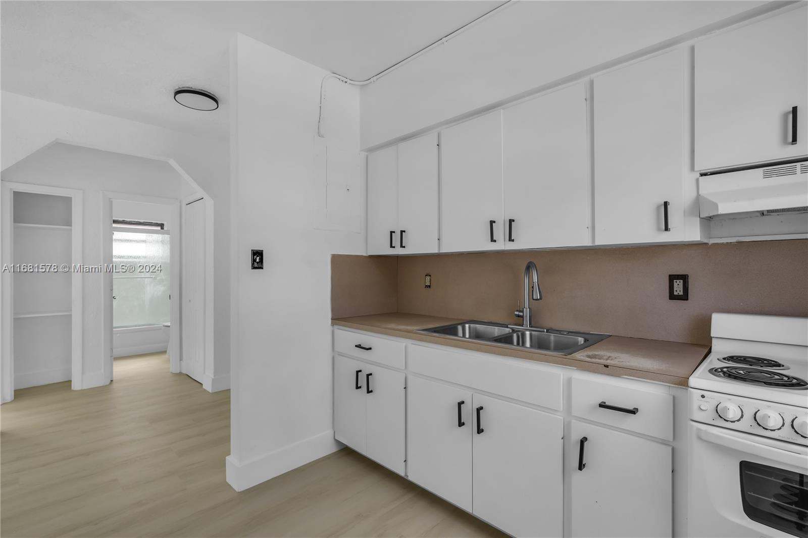 1400 Northwest 55th Street Miami, FL 33142 - Photo 8 of 33 a kitchen with granite countertop a sink and a stove