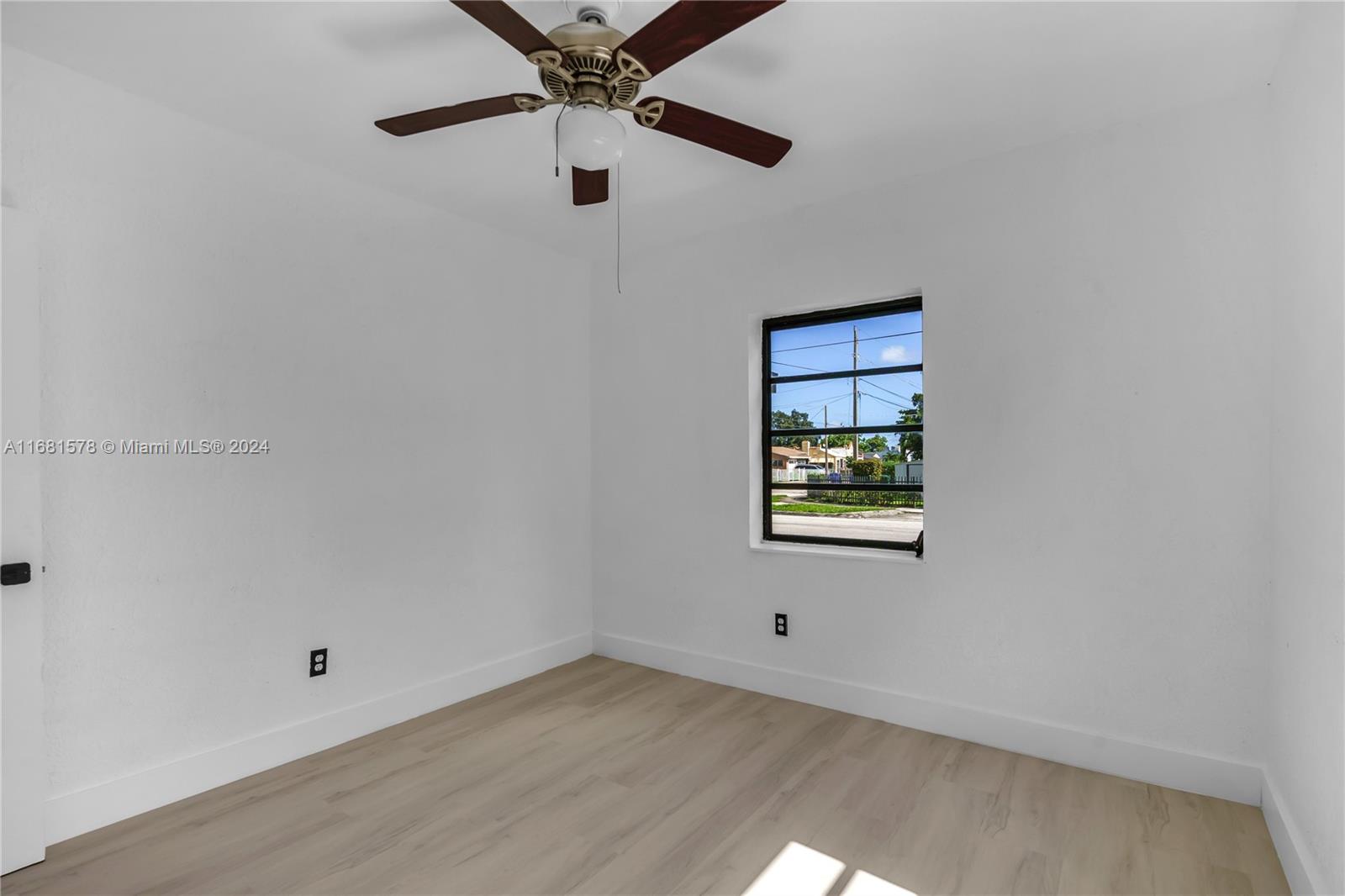1400 Northwest 55th Street Miami, FL 33142 - Photo 10 of 33 an empty room with a window and a ceiling fan