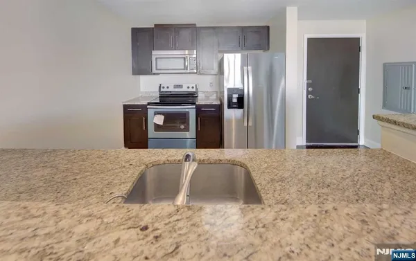 a kitchen with a refrigerator sink and stove