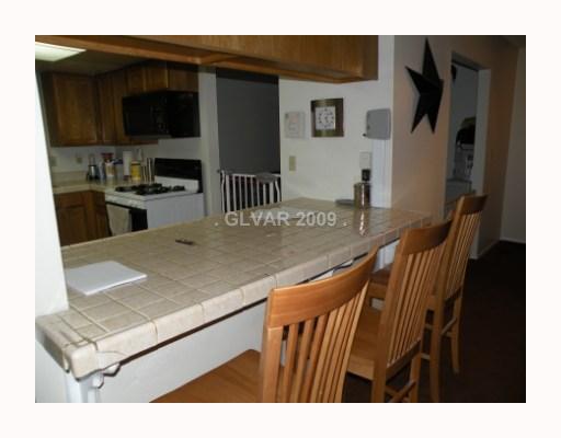 5518 West Viking Road Las Vegas, NV 89103 - Photo 12 of 12 Kitchen. Breakfast bar, open space between kitchen and family room