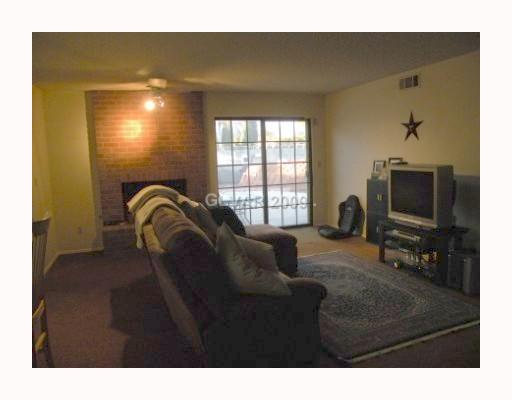 5518 West Viking Road Las Vegas, NV 89103 - Photo 7 of 12 Den. Large family room with fireplace and wet bar. Slider out to pool area and back yard.