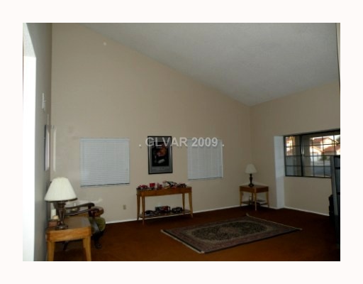 5518 West Viking Road Las Vegas, NV 89103 - Photo 10 of 12 Living Room. Vaulted Ceilings, separate living room in front of house looking out to front porch.