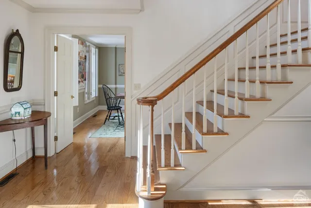 a view of entryway and hall with wooden floor
