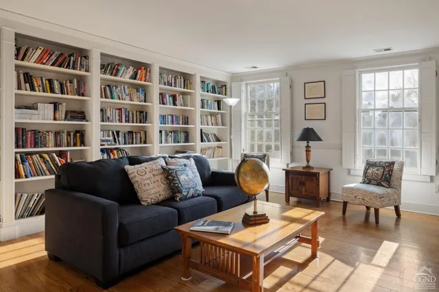 a living room with furniture and a book shelf