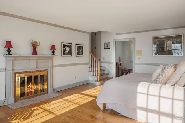 a bedroom with a bed and a fireplace