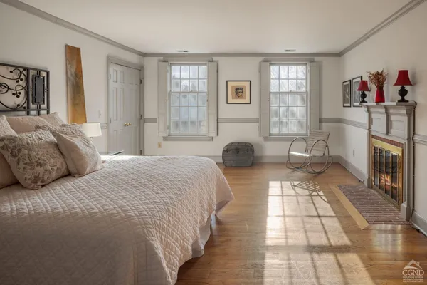 a bedroom with a bed and a fireplace