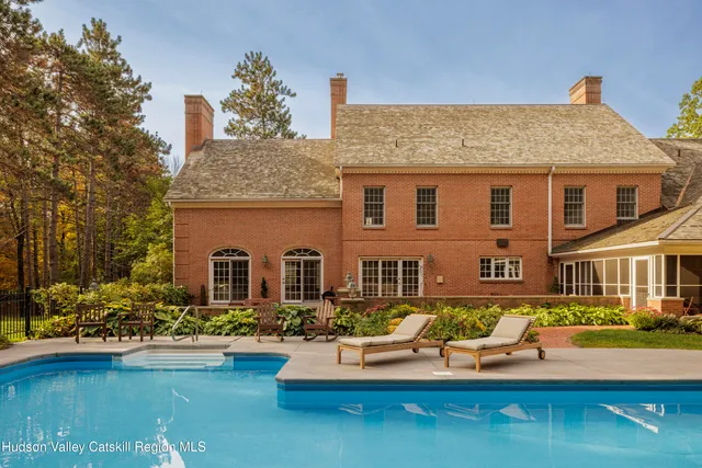 a kitchen with stainless steel appliances granite countertop a refrigerator a stove and a sink with wooden floor