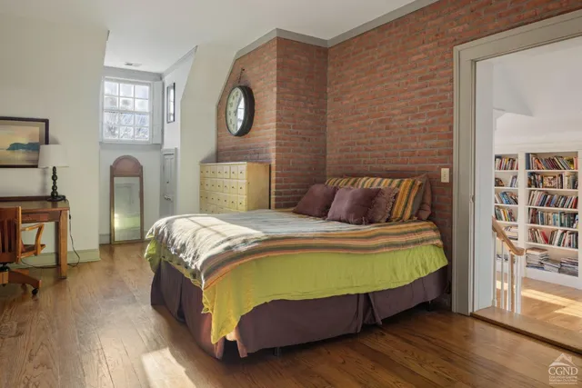 a spacious bedroom with a bed and a flat screen tv